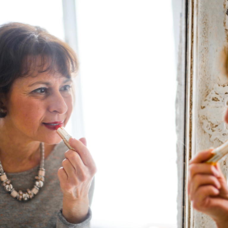 Woman applying lipstick